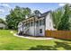 Side view of a beautiful home featuring a manicured lawn and a wooden fence at 1384 Sunrise Way, Lawrenceville, GA 30046