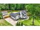 Aerial view of a home with a spacious yard, garage, and charming architectural details at 1384 Sunrise Way, Lawrenceville, GA 30046