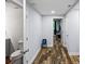 A hallway features wood floors and neutral walls with a bathroom and bedroom doors nearby at 1384 Sunrise Way, Lawrenceville, GA 30046