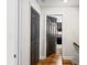 Hallway showcases wood floors, closet, and bedroom door that leads to a cozy bedroom at 1384 Sunrise Way, Lawrenceville, GA 30046