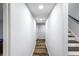 A hallway features wood floors, neutral walls, and recessed lighting. A stairway is to the right at 1384 Sunrise Way, Lawrenceville, GA 30046