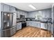 Modern kitchen with stainless steel appliances, gray cabinets, and backsplash at 1384 Sunrise Way, Lawrenceville, GA 30046