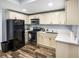 Kitchen featuring stainless steel appliances, white cabinetry, and modern countertops at 1384 Sunrise Way, Lawrenceville, GA 30046