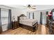 A bedroom featuring a wooden bed frame, hardwood flooring, and plenty of natural light from the windows at 1384 Sunrise Way, Lawrenceville, GA 30046