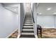 Stairway shows wooden floors and neutral walls, and a classic black handrail at 1384 Sunrise Way, Lawrenceville, GA 30046