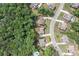 An aerial view shows how the home is nestled in a community with lush, mature trees at 3230 Sundew Nw Dr, Acworth, GA 30101