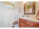 Well-lit bathroom with a tub-shower combo, decorative wall accents, and a stylish wooden-framed mirror at 3230 Sundew Nw Dr, Acworth, GA 30101