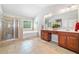 Bathroom with a tiled shower, a soaking tub, double sinks, vanity cabinets, and neutral-toned tile flooring at 3230 Sundew Nw Dr, Acworth, GA 30101