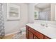 Well-lit bathroom featuring a single sink vanity and shower with patterned curtain at 3230 Sundew Nw Dr, Acworth, GA 30101