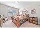 Comfortable bedroom with a cozy bed, a window with blinds, and traditional decor with warm colors and vintage accents at 3230 Sundew Nw Dr, Acworth, GA 30101