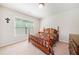Cozy bedroom features a four-poster bed, bright window, and neutral walls at 3230 Sundew Nw Dr, Acworth, GA 30101