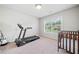 Bedroom with carpet flooring, a crib, a treadmill, and a large window with lots of natural light at 3230 Sundew Nw Dr, Acworth, GA 30101