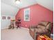 Bonus room featuring a rocking chair, recliner, carpet flooring, and a large window at 3230 Sundew Nw Dr, Acworth, GA 30101