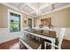 Dining room with a wooden table, bench seating, and natural light from large windows at 3230 Sundew Nw Dr, Acworth, GA 30101