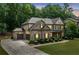 Beautiful two-story home with a three car garage and manicured lawn at 3230 Sundew Nw Dr, Acworth, GA 30101