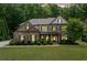 Charming two-story brick home with manicured lawn and inviting curb appeal amongst mature trees at 3230 Sundew Nw Dr, Acworth, GA 30101