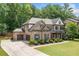 Beautiful home showcases a brick exterior, a two-car garage, and manicured landscaping at 3230 Sundew Nw Dr, Acworth, GA 30101