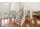 Elegant foyer showcasing hardwood floors, a staircase with wrought iron railings, and high ceilings with plenty of light at 3230 Sundew Nw Dr, Acworth, GA 30101