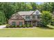 Charming two-story brick home featuring a well-manicured lawn and professional landscaping at 3230 Sundew Nw Dr, Acworth, GA 30101
