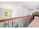 Upstairs hallway featuring hardwood railings, chandelier and views to the foyer below at 3230 Sundew Nw Dr, Acworth, GA 30101