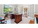 Spacious office with a large desk, wood floors, and glass French doors at 3230 Sundew Nw Dr, Acworth, GA 30101