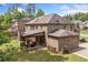 Beautiful brick home with covered patio and lush backyard landscaping at 3230 Sundew Nw Dr, Acworth, GA 30101