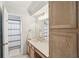 Bathroom featuring wooden cabinets, spacious countertop, and shower with neutral striped curtain at 267 Somerlane Pl, Avondale Estates, GA 30002