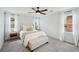 Bright bedroom with a plush bed, bench, and ample natural light from dual windows at 267 Somerlane Pl, Avondale Estates, GA 30002