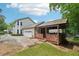 Well-maintained home exterior with a covered patio, attached garage, and lush green landscaping, creating an inviting outdoor space at 267 Somerlane Pl, Avondale Estates, GA 30002