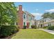 Charming townhome featuring a red front door, brick chimney, and well-manicured lawn at 267 Somerlane Pl, Avondale Estates, GA 30002