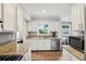 Bright kitchen featuring stainless steel appliances, granite countertops, and white cabinets at 267 Somerlane Pl, Avondale Estates, GA 30002