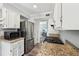 Modern kitchen with stainless steel appliances, granite counters, and white cabinets providing ample storage at 267 Somerlane Pl, Avondale Estates, GA 30002