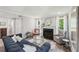 Cozy living room featuring a fireplace, hardwood floors, and large windows with natural lighting at 267 Somerlane Pl, Avondale Estates, GA 30002