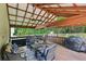 Inviting covered patio with a cozy seating area, dining table, and grill, great for outdoor gatherings and casual dining at 267 Somerlane Pl, Avondale Estates, GA 30002