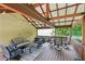Well-appointed covered patio with a seating area, dining set, and grill, perfect for relaxing and enjoying outdoor meals at 267 Somerlane Pl, Avondale Estates, GA 30002