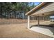 Covered back porch overlooking a spacious backyard with mature trees at 3415 Linstead Ct, Loganville, GA 30052