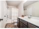 Well-lit bathroom featuring modern fixtures, wood look floors, and a shower-tub combo at 3415 Linstead Ct, Loganville, GA 30052