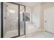Modern bathroom featuring separate shower and soaking tub with marble surround at 3415 Linstead Ct, Loganville, GA 30052