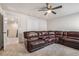 Large bonus room featuring neutral carpeting, ceiling fan, and oversized sectional sofa at 3415 Linstead Ct, Loganville, GA 30052