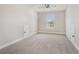 Spacious bonus room with neutral carpet and ample natural light from a window at 3415 Linstead Ct, Loganville, GA 30052