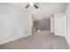 An expansive bonus room with neutral carpeting, ceiling fan, and access to stairs at 3415 Linstead Ct, Loganville, GA 30052