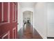 Inviting entryway with hardwood floors leading to an open-concept living space with view of fireplace at 3415 Linstead Ct, Loganville, GA 30052