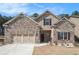 Charming brick home with a two-car garage, landscaped front yard, and inviting front entrance at 3415 Linstead Ct, Loganville, GA 30052