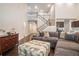 Spacious living room with high ceilings, an open staircase, and hardwood floors at 3415 Linstead Ct, Loganville, GA 30052