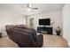 Inviting living room featuring a ceiling fan and entertainment center with fireplace at 3415 Linstead Ct, Loganville, GA 30052