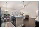 Open concept living space featuring a kitchen island, dining area, and spacious living room at 3415 Linstead Ct, Loganville, GA 30052