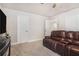Comfortable living room with plush, leather seating and soft carpet flooring at 3415 Linstead Ct, Loganville, GA 30052