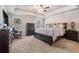 Spacious main bedroom featuring a tray ceiling, ceiling fan, and dual windows at 3415 Linstead Ct, Loganville, GA 30052