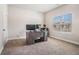 Bright home office space with a large desk and neutral carpeting throughout at 3415 Linstead Ct, Loganville, GA 30052