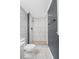 Bathroom showing shower with white and gray tile, pebble floor, and modern fixtures at 6997 Vesta Brook Dr, Morrow, GA 30260